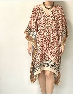 Item - Designer Cotton Kaftan / Tunic Fabric - 100% Cotton Size - Free Size * It has Adjustable Drawstring Waist. * Very comfortable to wear in both hot or cold weather. Hand Block Print Short Cotton Kaftan is a fashionable and comfortable garment known for its traditional handcrafted prints, use of breathable cotton fabric, short length, loose fit, and versatile design. It's a great addition to your wardrobe for both style and comfort, especially in warm weather. This Beautiful Hand Block Print Tunic or can be called as Kaftan is made with super fine quality cotton and designs have been crafted by Hand Prints.   The magic of Block prints using wooden blocks and natural dyes in small villages of Rajasthan, flowing into Comfortable west Stylish Kaftans . Cotton Fabric: The use of cotton fab Bohemian V-neck Kaftan For Vacation, Bohemian Patterned Dress For Vacation, Patterned V-neck Boho Dress For Vacation, Patterned Bohemian Vacation Dress, Hippie V-neck Beach Tunic, Beach Hippie V-neck Tunic, Bohemian Patterned Dress For Beach Season, Bohemian Patterned Beach Dress, Bohemian Printed Kaftan For Festivals