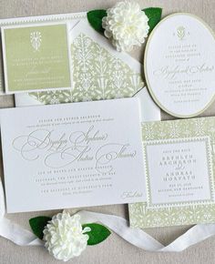 the wedding stationery is laid out on top of each other