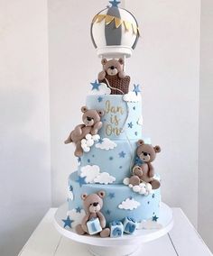 a three tiered cake with teddy bears on it