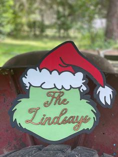 there is a sign that says the lindaays with santa's hat on it