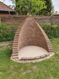 an outdoor sand pit made out of bricks