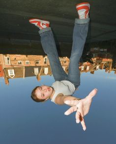 a man flying through the air while riding on top of a skateboard with his feet in the air