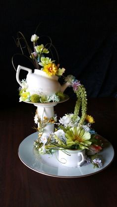 there is a tea pot with flowers on it