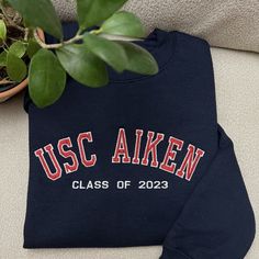 "If you want sleeve embroidery, add this add-on to your cart: https://customembshirts.etsy.com/listing/1156973414 One stitch at a time, let's create something beautiful together. Our custom embroidered sweatshirts are the ultimate personalized gift for any occasion. These cozy essentials are available as crewnecks or hoodies and feature from minimalist to classic jersey-style embroidery for a touch of nostalgia and personalization. Crafted for both comfort and style, these sweatshirts offer a un College Cotton Sweater With Embroidered Graphics, Cotton College Sweater With Embroidered Graphics, Crew Neck Hoodie With Embroidered Logo For College, Crew Neck Sweatshirt With Letter Embroidery For College, Varsity Cotton Sweater With Embroidered Logo, Sporty Long Sleeve Sweatshirt With Custom Embroidery, Varsity Crew Neck Sweatshirt With Custom Embroidery, Crew Neck Sweater With Embroidered Text For College, Cotton Sweatshirt With Letter Embroidery For Campus