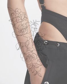 a woman's arm with flowers on it, and the word love written in black ink