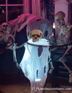 two skeletons are sitting in front of a table with a lit candle and some candles