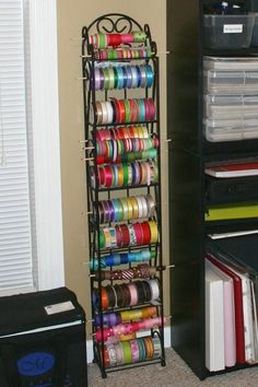 a book shelf filled with lots of different colored tapes