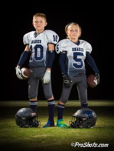 two young football players are posing for a photo