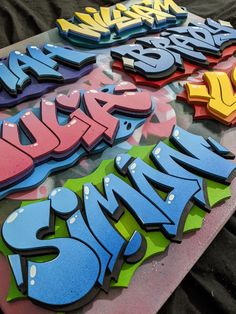 some type of graffiti on a table with the word swm spelled in different colors