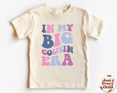 In my Big Cousin Era, Trendy Kid Shirt, ,Funny Toddler Shirt, Pregnancy Reveal T-Shirt, Siblings Shirt,  Cousin Natural Body, Cousin Sweater ✧ All of the t-shirts and bodysuits at our shop are made of 100% certified pure organic cotton. Elegant t-shirt with round neckline and short sleeves. The loose fit and softness of the cotton gives you freedom of movement. ✧Our sweatshirts are very soft, cute and lightweight, bound to keep you warm. Kid's unisex cotton blouse made of cotton with elastic at Playful Letter Print T-shirt For Gender Reveal, Fun Tops With Funny Print For Gender Reveal, Funny Letter Print T-shirt For Gender Reveal, Gender Reveal Graphic Tee With Funny Text, Funny T-shirt For Gender Reveal With Letter Print, Funny Toddler Shirt, Funny Toddler, Sibling Shirts, Toddler Humor