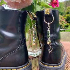 How do I customize my boot charms ? --> When you order, leave me a message with themes/colors/styles you would like !! You can also message me with inspo images/Pinterest board/etc. :) Details : --> charms clip onto pull-loops of boots - easy to add or remove the clips  --> avoid contact with water if possible  --> possibility of scuffs on the back of boots from repeated contact What's included in the cost ? --> communication about custom aspects --> materials: clips, wire, bead type ( some specialty stones/glass cost me more ),  --> my time: coming up with a concept, laying out concept, making it by hand Boot Charms, Bellingham Wa, Boots Accessories, Custom Boots, Shoe Clips, Pinterest Board, Clothing Ideas, Like You, Charms