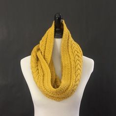 a yellow knitted scarf on a mannequin