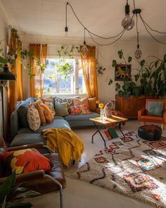 a living room filled with furniture and lots of plants