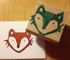 a rubber stamp with an image of a fox and a bird on it's face