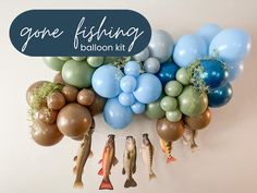 a bunch of balloons and fish hanging on the wall with some saying gone fishing balloon kit