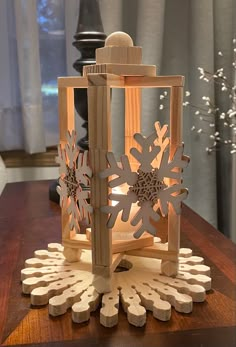 a wooden lantern with snowflakes on it