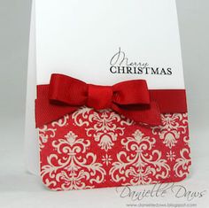 a card with a red bow on it