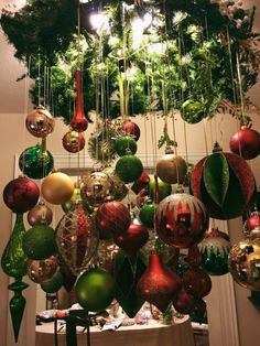 an assortment of christmas ornaments hanging from a chandelier