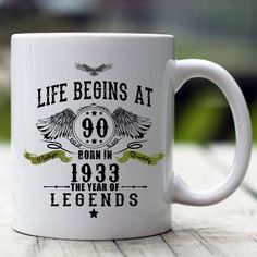 a white coffee mug with the words life begins at 26 born in 1953 and legend