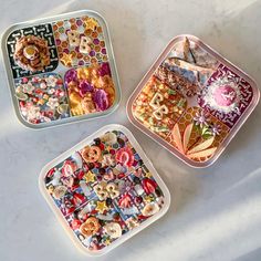 three plastic trays filled with different types of food on top of a white table