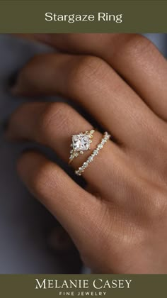 a woman's hand with a ring on her finger and the words stargaze ring