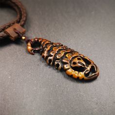 ❤This unique bone carved Scorpion Guru pendant is made by Tibetan craftsmen in Hepo Township, Baiyu County, the birthplace of the famous Tibetan handicrafts.It's carved yak bone,brown color,2.2 inch height.You can make it into necklace,or mala pendant.❤Details Material:yak bone Size: Height:56mm / 2.2 inches Width: 22mm / 0.87 inches ❤Free Gift : Cowhide Cord Color:brown Length:68cm / 26.8inches Width:4mm / 0.16inches You'll get 1 * scorpion pendant as pictures shown. Brown Carved Amulet Necklaces, Bohemian Carved Brown Jewelry, Bohemian Brown Carved Jewelry, Unique Carved Brown Necklace, Brown Carved Pendant Necklace, Adjustable Carved Brown Necklace, Unique Brown Carved Necklace, Traditional Brown Engraved Jewelry, Artisan Brown Etched Jewelry