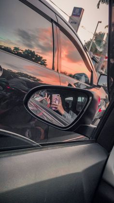 the side view mirror of a car is reflecting cars in it's rear view mirror