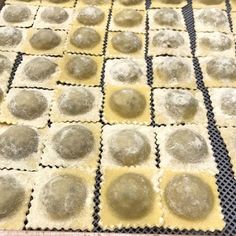 some ravioli sitting on top of a black and white checkered table cloth with holes in it