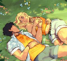 two people laying in the grass with one person touching his face and another holding him