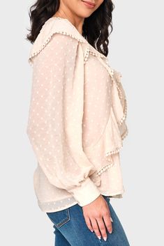 The Ophelia Ruffle Boho Blouse is made in a sheer chiffon fabric that features a textured dot, while the romantic trimmed ruffles add a touch of femininity. Perfect for any occasion, this blouse is a must-have addition to your wardrobe. 100% Polyester Delicate Wash Cycle, Lay Flat to Dry Length 25 1/2" (size small) Eased Fit Crew Neck Long Sleeve with 2-Button Cuff Lined Except Sleeves Easy 30-Day Returns & Exchanges Sabrina is 5'7 and wearing XS Feminine Blouse With Ruffle Hem And Ruffled Collar, Feminine Ruffled Blouse For Daywear, Chic Polka Dot Blouse With Ruffles, Feminine Long Sleeve Polka Dot Blouse, Feminine Polka Dot Swiss Dot Blouse, Elegant Polka Dot Swiss Dot Blouse, Feminine Flowy Cream Blouse, Feminine Polka Dot Party Blouse, Spring Swiss Dot Tops With Ruffled Collar