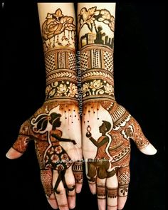 two hands with henna designs on them