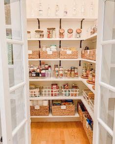 an open pantry with lots of food in baskets and containers on the shelves next to doors