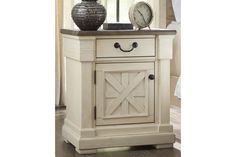 a white nightstand with a clock on top of it