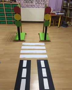 two children's play area with cut out street signs and traffic lights on the floor