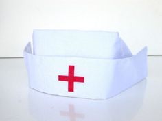 a white box with a red cross on the front and side is sitting on a table