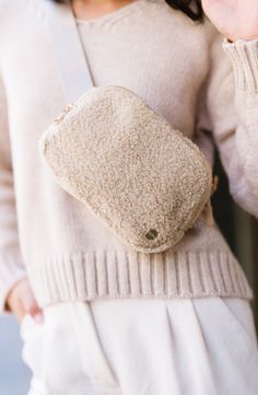 A chill in the air calls for cozy accessories. Enter: The Aspen Sherpa Belt Bag. With its soft fleece material, adjustable strap (intended to fit over sweaters, vests, and coats), and glam gold hardware, you're sure to be reaching for this fanny pack all season long. Details: 8.5" long x 5.5" height x 2.25" wide Back zippered pocket is 6.5" long x 4" wide (fits a phone!) Strap adjusts from 21"-39" end to end 3 interior mesh pockets Fuzzy soft sherpa fabric Stunning contrasting gold hardware Sherpa Belt Bag, Sherpa Fabric, Cozy Accessories, Phone Strap, Hottest Fashion Trends, Timeless Accessories, Boutique Brands, Modern Chic, Apparel Design