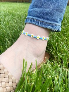 Blue Daisy Anklet Blue seed beads with white seed beads 3mm seed beads Anklet comes as shown* Sunflower Anklet sold separately  Other color options available, please select custom colors and add colors to personalized section.  Made from beads with durable elastic. Average ankle size is 9. Please select ankle size. CARING TIPS FOR YOUR JEWELRY ⭐️Treat and store with care. ⭐️ For longevity, avoid exposing your jewelry to water. ⭐️ Avoid having direct contact with lotions, perfumes, sanitizers as these chemicals may cause discoloration of your jewelry. Spring Anklets With Colorful Beads, Colorful Beaded Anklets For Spring Gift, Adjustable Anklets For Spring Gift, Spring Gift Anklets With Colorful Beads, Adjustable White Anklets For Spring, Casual Ankle Strap Anklets For Spring, Handmade Adjustable Anklets For Spring, White Beaded Anklets For Summer, Bohemian Beaded Anklets For Spring