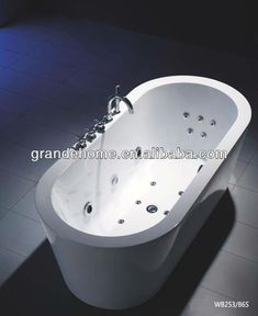 an oval shaped bathtub with faucet and shower head