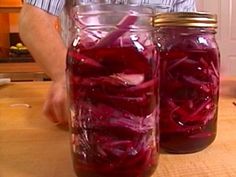 two mason jars filled with pickled red onions