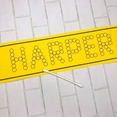 a yellow sign with the word march on it next to a pair of screws