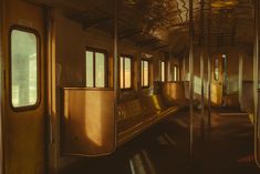 the inside of a train car with lots of windows and door handles on each side