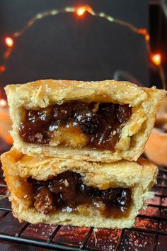 two pastries sitting on top of a cooling rack next to each other with lights in the background