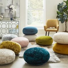 a living room filled with lots of different colored pillows