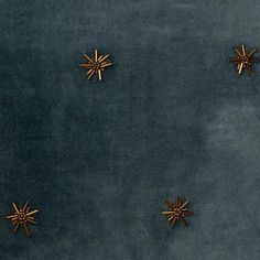 four gold stars on a blue velvet background