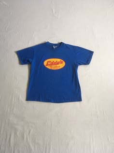 "vintage 1990s t-shirt Eddy's Groceries Olympia, WA Hanes Beefy T, 100% pre-shrunk cotton blue w/yellow/red print good vintage condition, light wear-light fade spots-see photos label size adult L-see below measures, lying flat, shoulder-19\" sleeve-7 1/2\" chest-20 11/2\" length-27\"" Blue Vintage Clothes, Vintage 90s Aesthetic Outfits, 90s Shirts Vintage, Vintage T-shirt, Light Blue Clothes, Vintage T Shirt Design, Class Shirt, Corner Store, Baggy Clothes