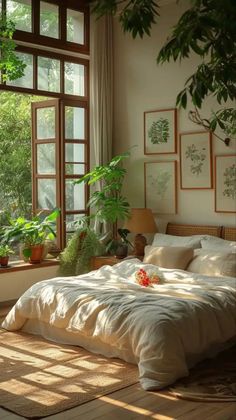 a bed sitting in a bedroom next to a window with lots of plants on it