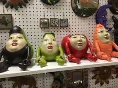 there are many ceramic figurines on the shelf