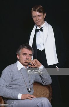 two men in tuxedos are posing for the camera