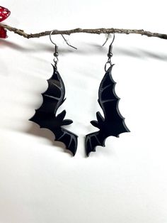 Unleash your dark side with our Gothic Bat Earrings from Eerie Emporium. These gothic earrings feature sleek black bats suspended from black hooks, perfect for adding a spooky flair to your Halloween ensemble. Whether you're dressing up for a party or embracing your gothic style year-round, these earrings are a must-have. Crafted for those who love unique and edgy jewelry, they make the perfect gift or a statement piece for your own collection. Bat Earring, Spooky Jewelry, Vampire Earrings, Black Hooks, Bats Halloween, Goth Earrings, Edgy Jewelry, Bat Earrings, Gothic Earrings