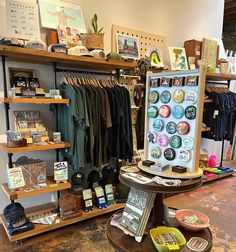 a room filled with lots of different items and shelves full of shirts, hats, and other things